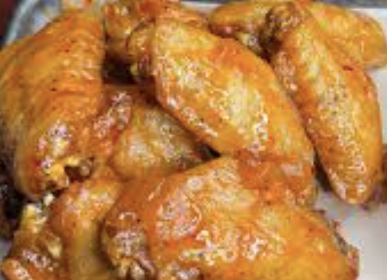 Sassafras Saloon signature dishes Crawfish Étouffée Fries
Crawdog
Cajun Smoked Chicken Wings
